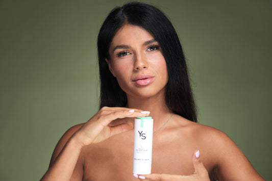 Model presenting YoungerSkin Product Bottle in Photo-Studio environment